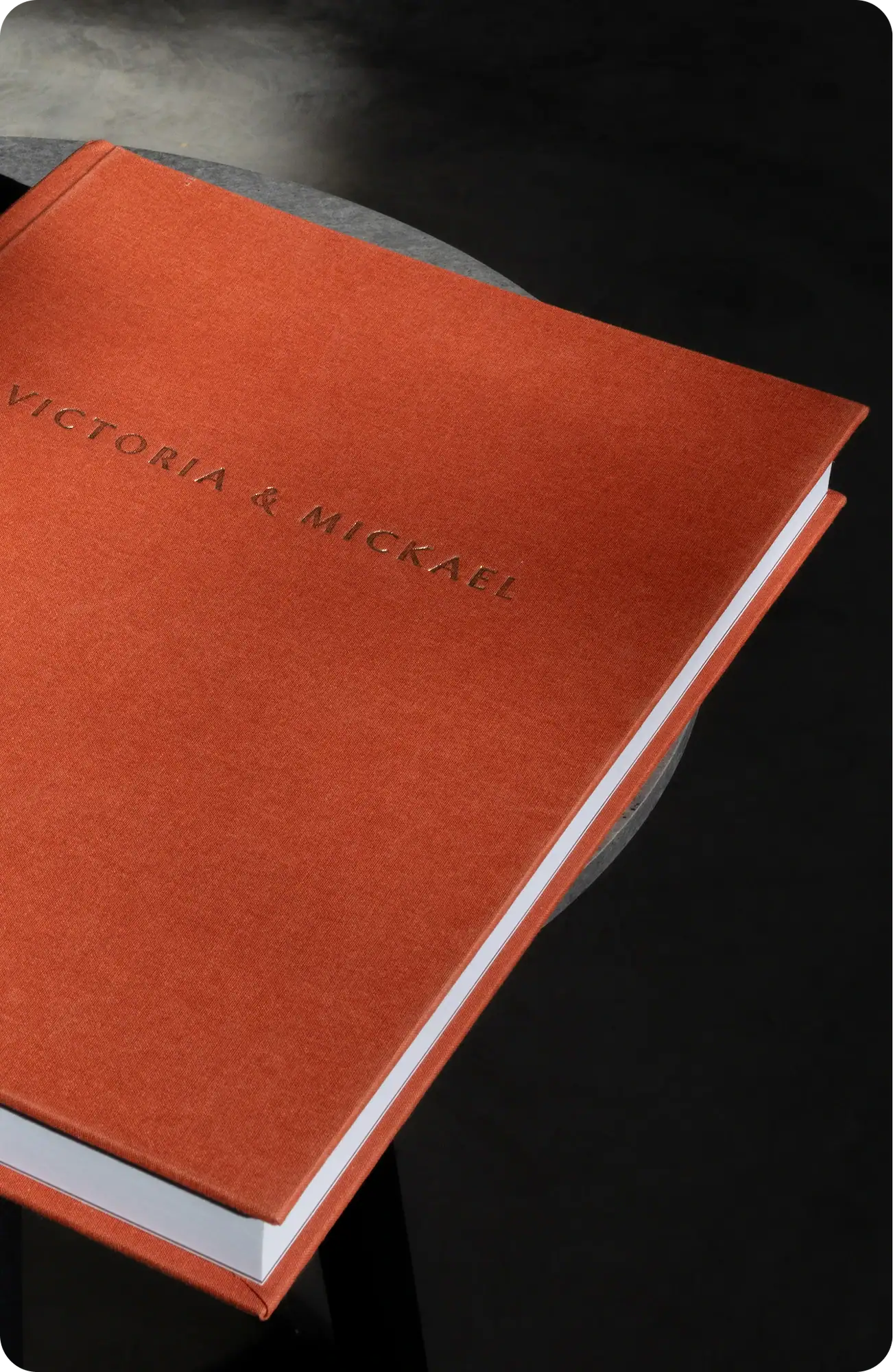 Bookbinding materials with orange cover for craft and binding projects.