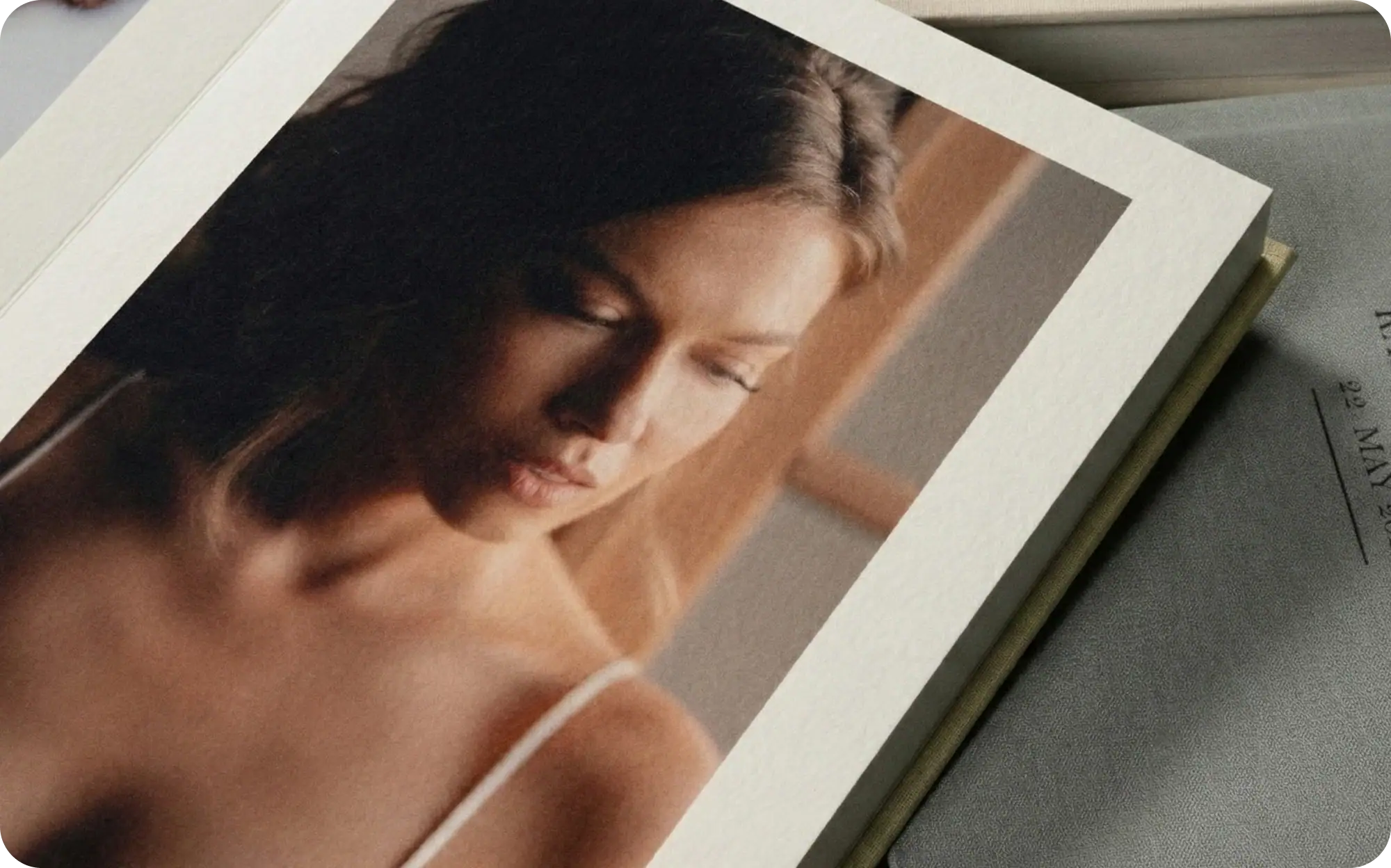 Close-up of a woman with papers, focusing on paper textures and design.