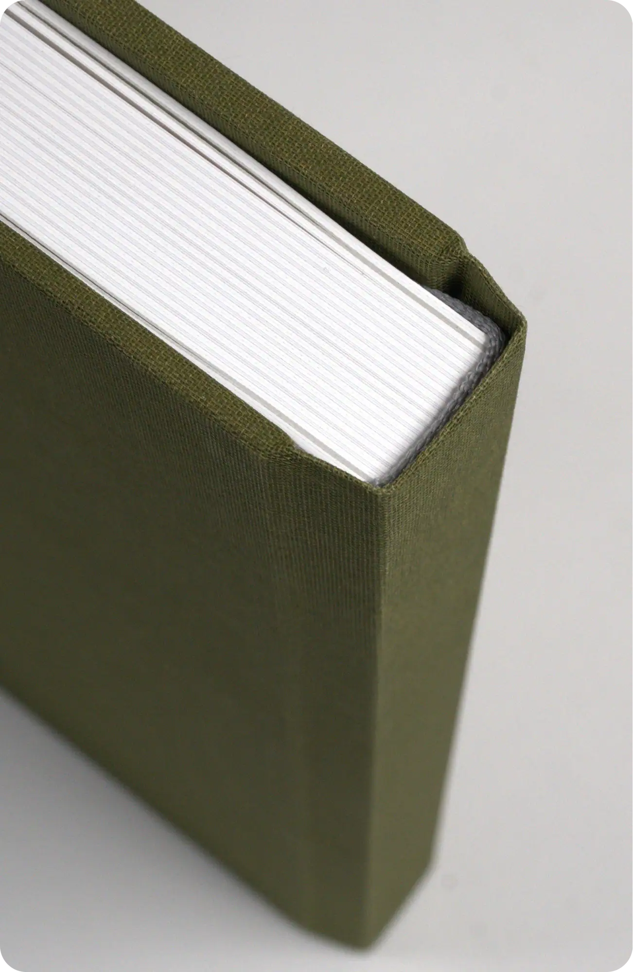 Green hardcover binding material for books and crafts, close-up view.