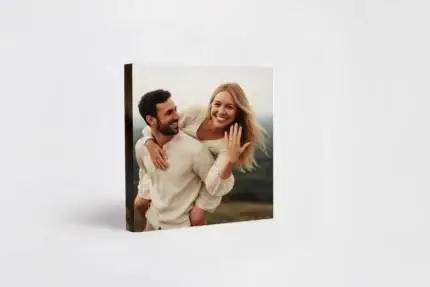 Engagement photo of a happy couple outdoors for album cover.