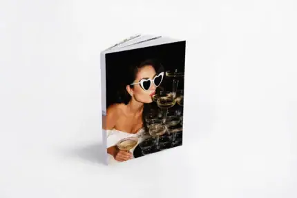 Woman with heart-shaped sunglasses at bridal shower with champagne glasses.