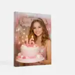 Young woman celebrating her Sweet 16 birthday with a pink cake and a big "16" candle.