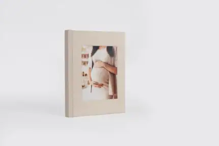 Elegant travel album featuring a pregnant woman holding her belly.