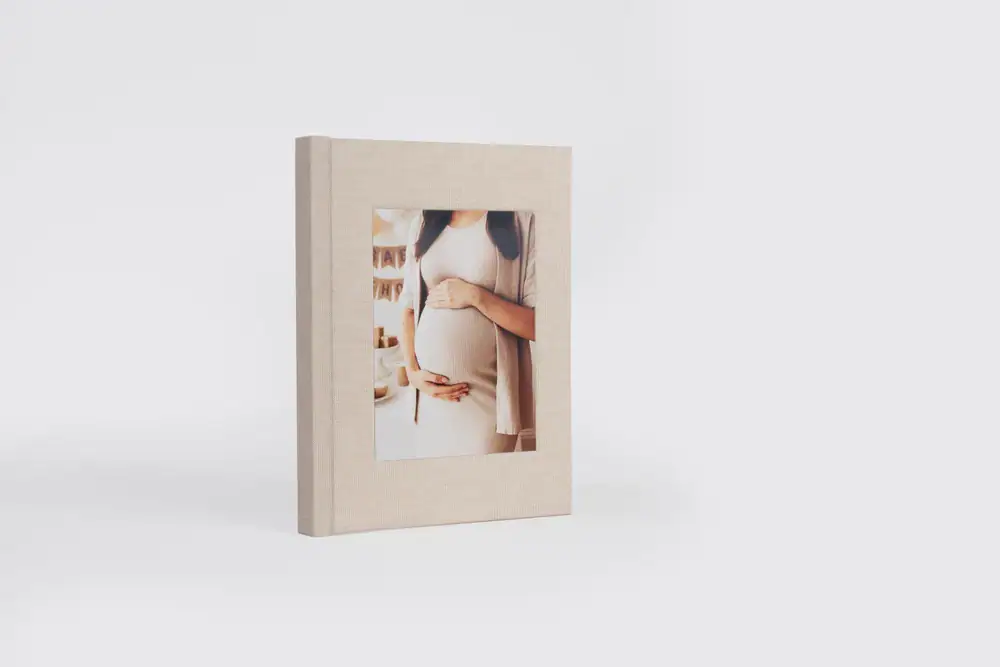Elegant travel album featuring a pregnant woman holding her belly.