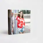 Young girl smiling at a graffiti wall, celebrating her Bat Mitzvah with vibrant colors.
