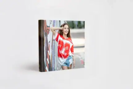 Young girl smiling at a graffiti wall, celebrating her Bat Mitzvah with vibrant colors.