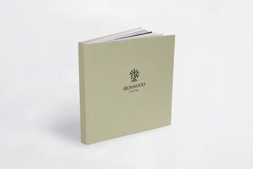 Baby shower album with "Ironwood Capital" logo on light green cover.