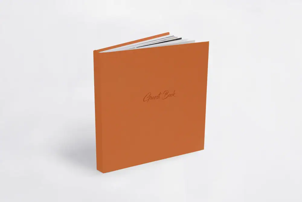 Orange family album with "Family Book" text on cover, on white background.