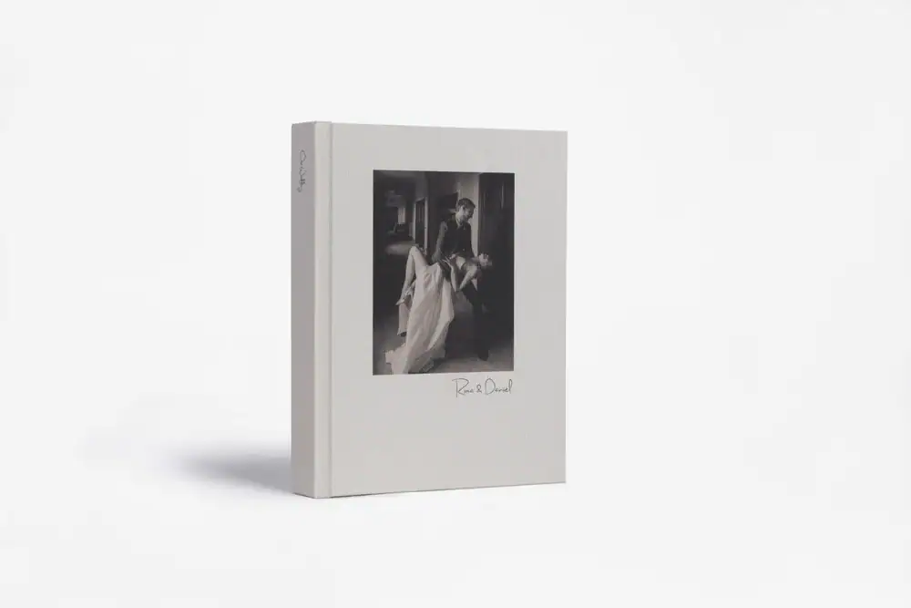 Black and white photo of a woman reading a book on the cover.