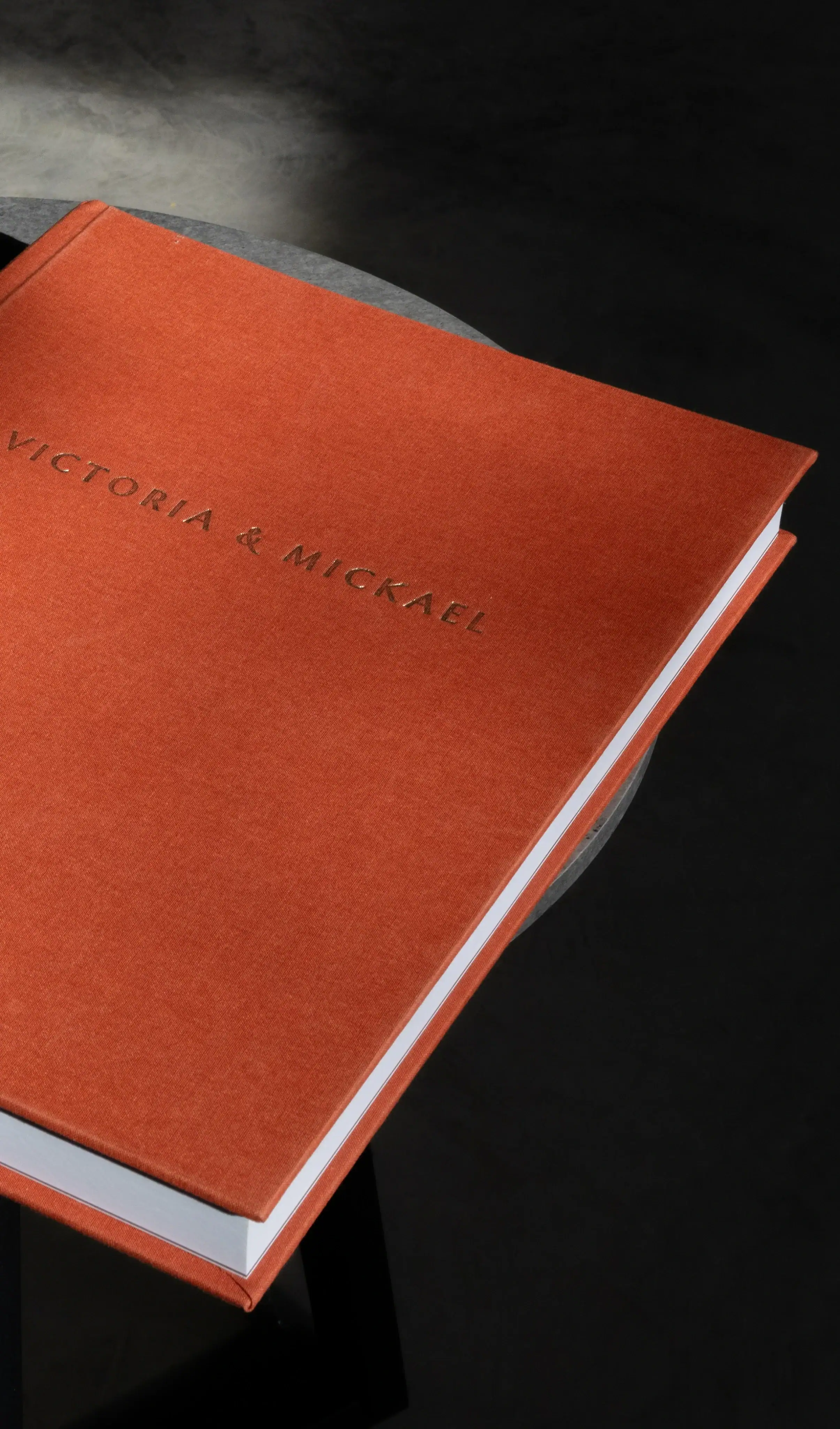 Bookbinding materials with orange cover for craft and binding projects.