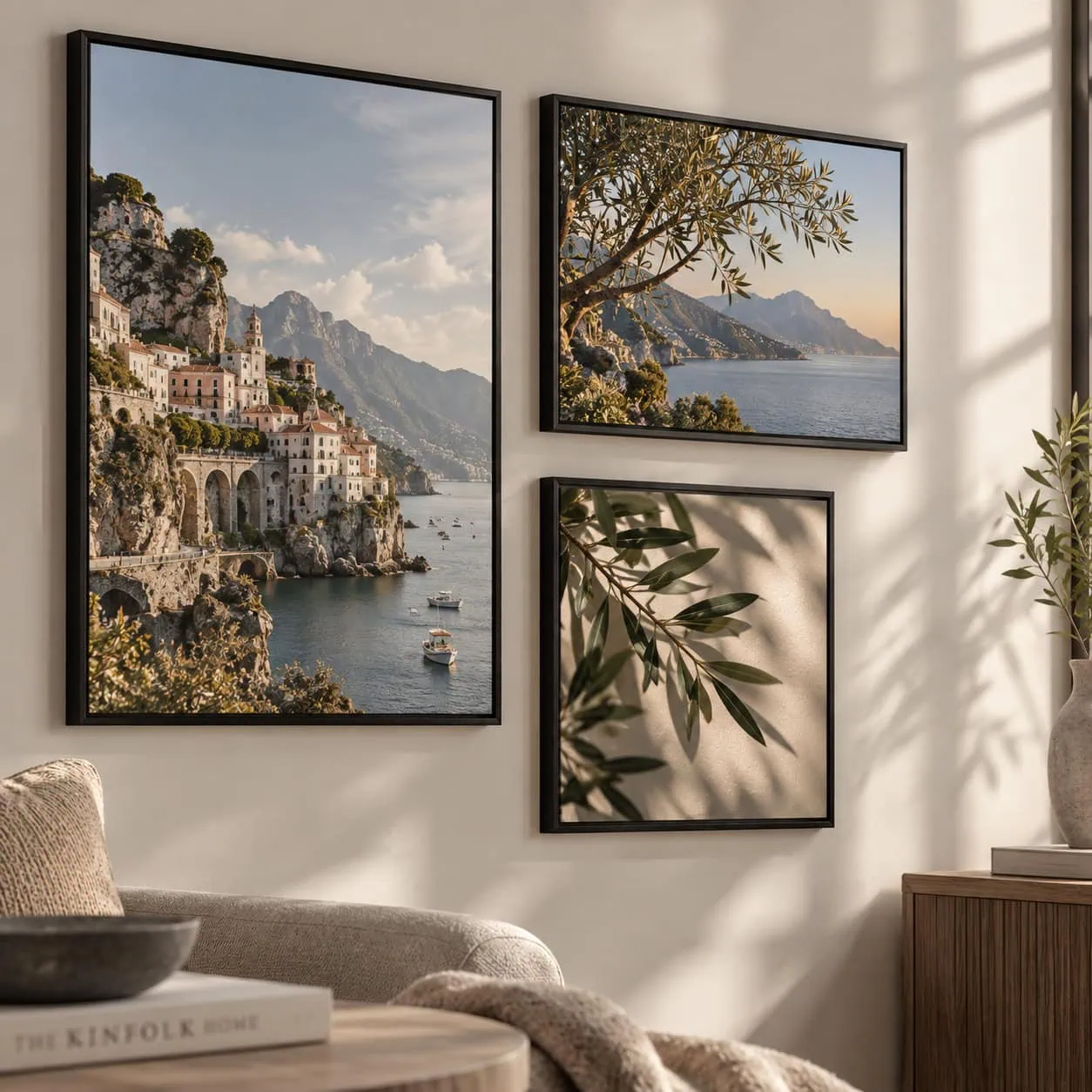 Set of three framed giclée art prints of coastal scenery on a living room wall.